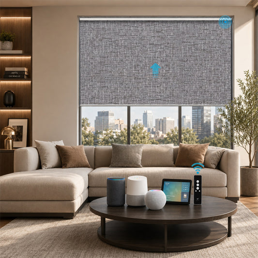A modern living room with a beige sectional sofa, round dark wood coffee table, and a large window featuring a gray textured roller blind. Smart home devices and a tablet sit on the table, and a city skyline is visible outside the window.