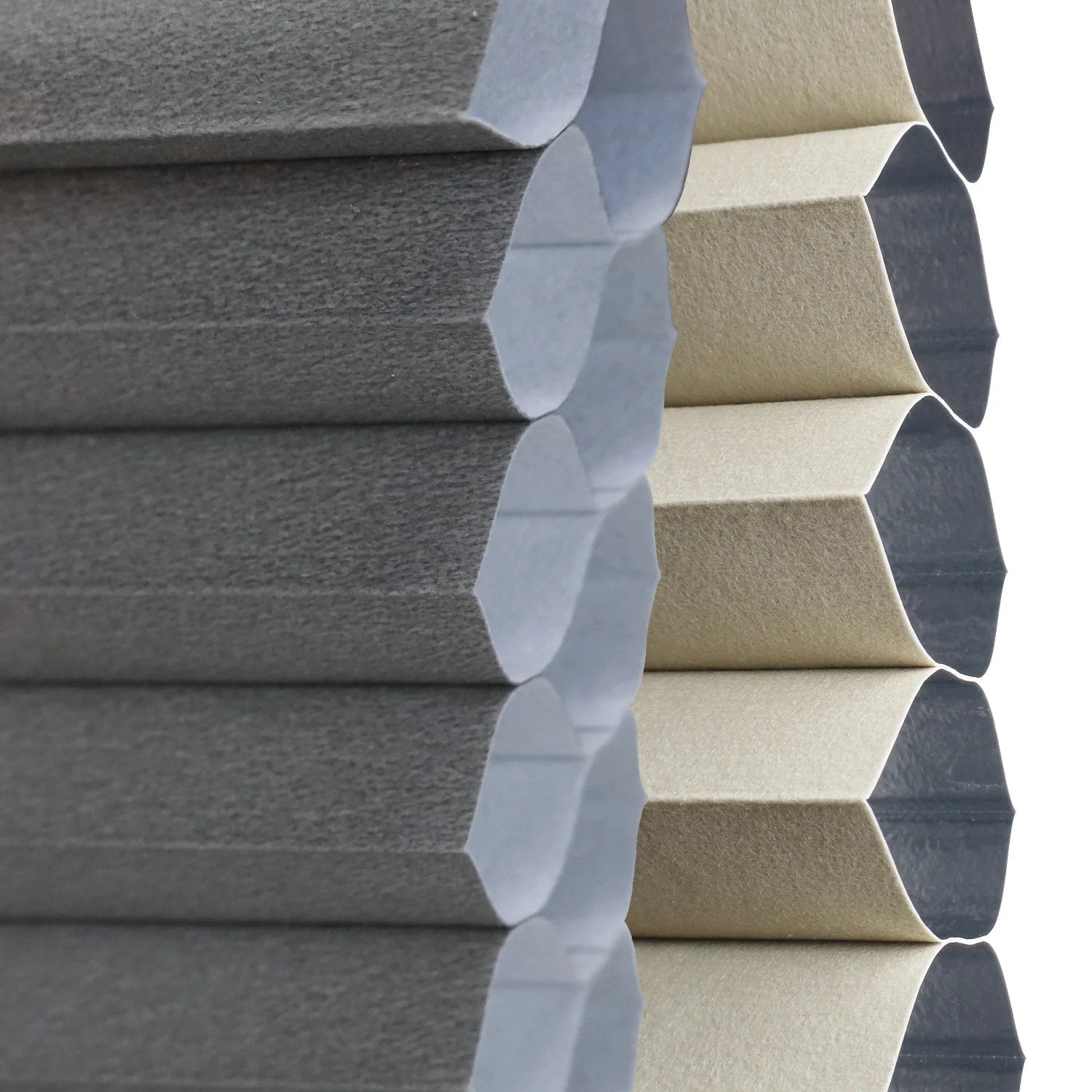 Close-up of hexagonal foam panels in two colors: dark gray on the left and light beige on the right, showing their textured surfaces and layered structure.