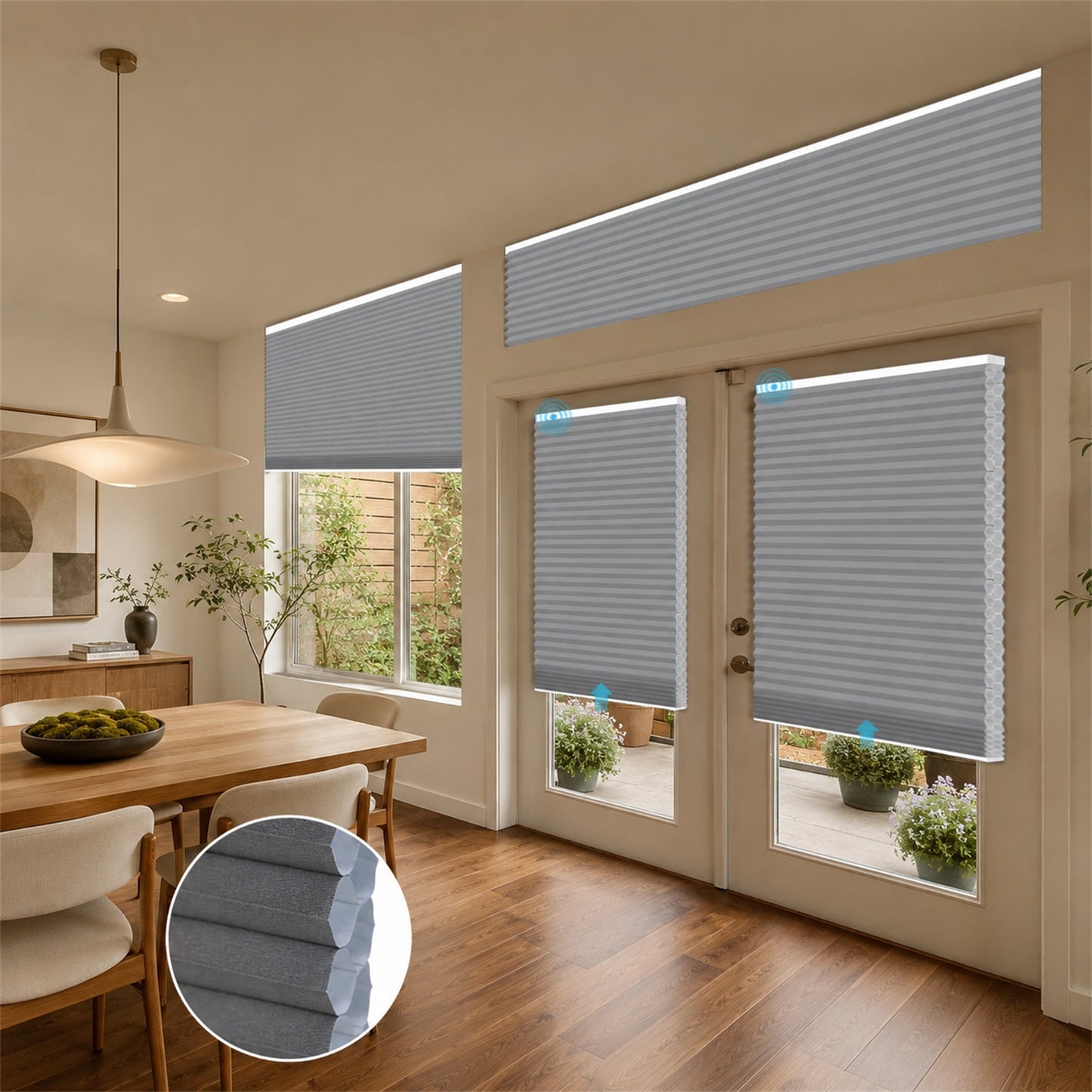Gray cellular window and door blinds installed in a modern dining room and patio area, with an inset circular detail of the fabric texture.
