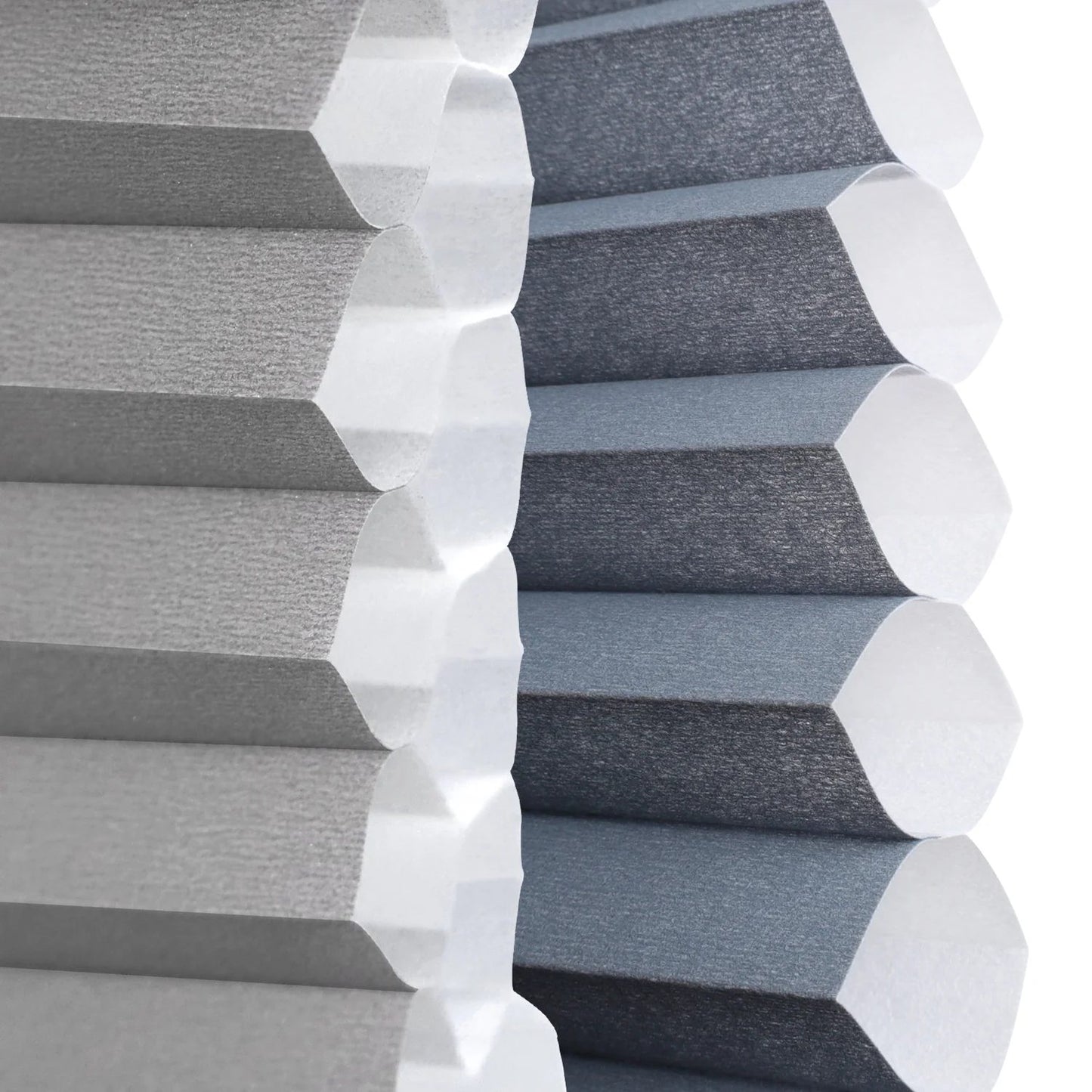 Close-up of gray pleated window blinds with a hexagonal design, showing both the light gray outer fabric and the darker charcoal inner lining.