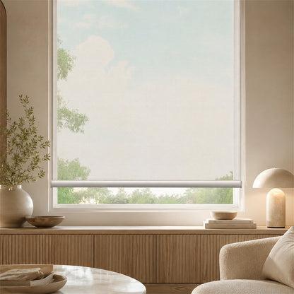 A light beige roller blind partially drawn over a large window in a modern, minimalist room with warm wood paneling, a table lamp, and a neutral chair.
