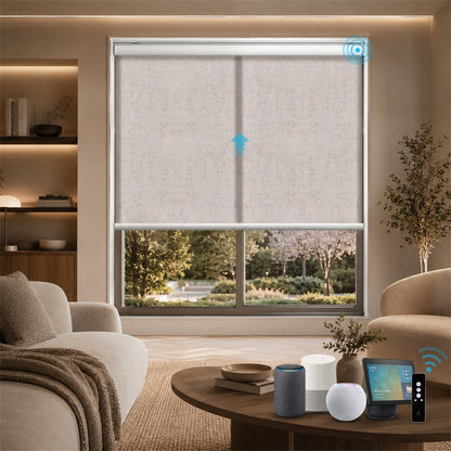 A modern roller blind system installed in a large window of a contemporary living room. The beige textured roller blind is partially drawn, revealing an outdoor garden view.