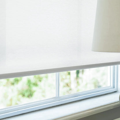Window with white blinds and a lampshade