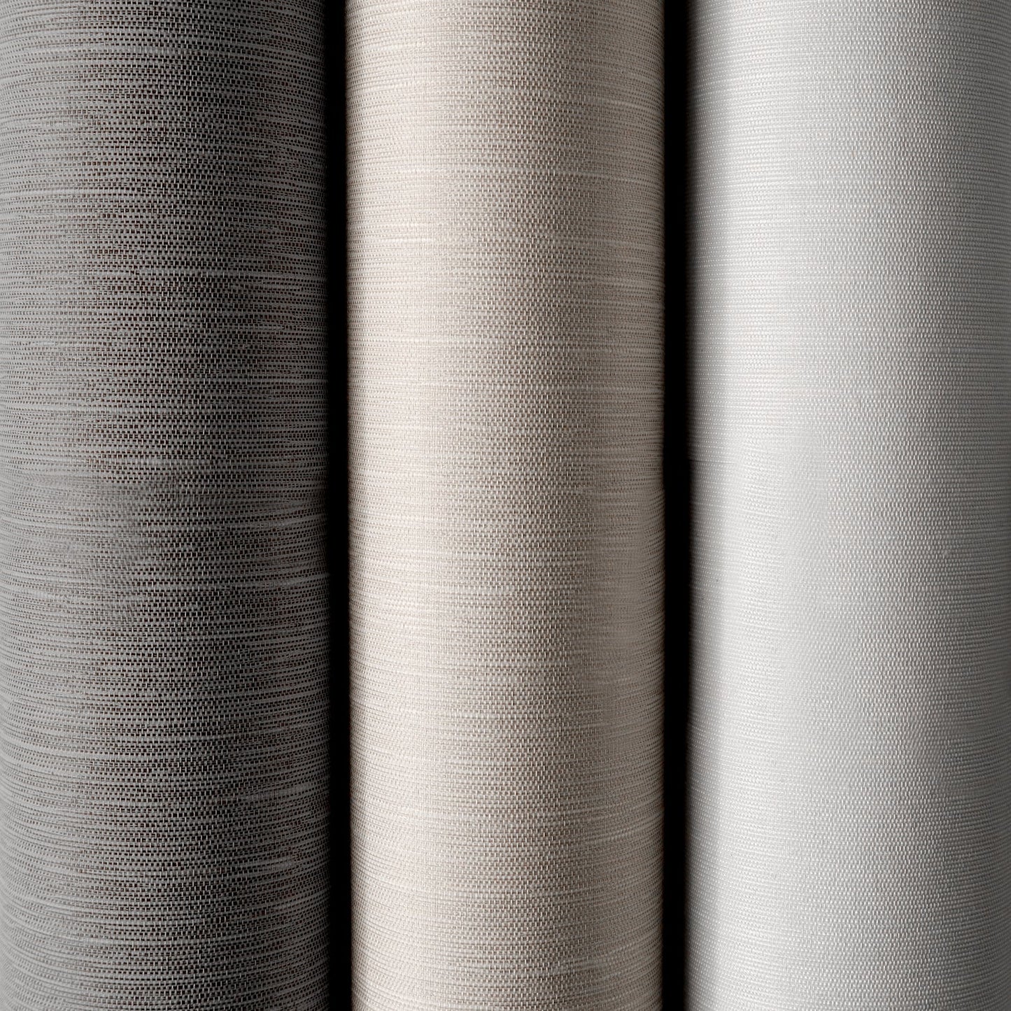 Close-up of three different gray fabric swatches with varying textures.