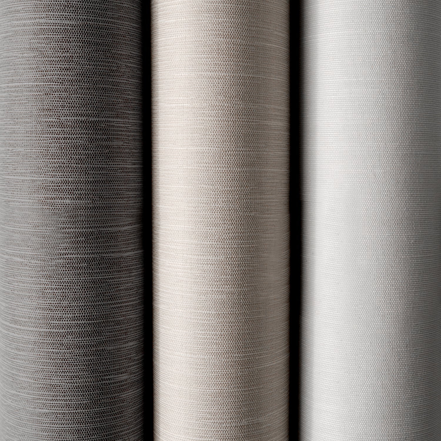Close-up of three different gray fabric swatches with varying textures.