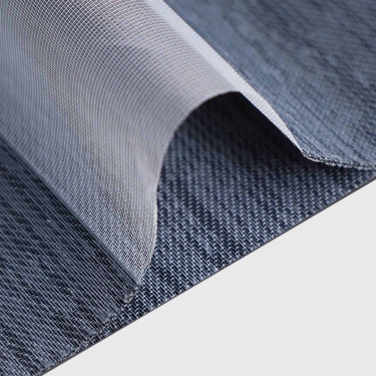 Close-up of textured blue fabric with a white background